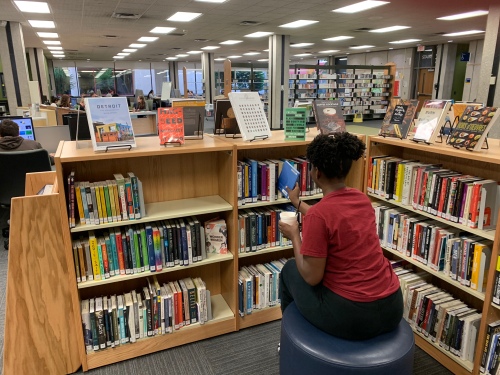 Student enjoying coffee in the New Books area 